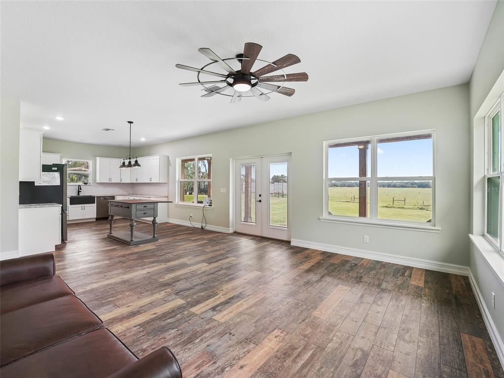 8567 Cr 635 Bushnell Bushnell, FL 33513 - Photo 11 of 46 a view of a livingroom with furniture chandelier fan and windows