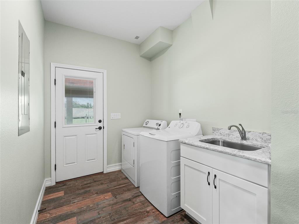 8567 Cr 635 Bushnell Bushnell, FL 33513 - Photo 20 of 46 a utility room with cabinets washer and dryer