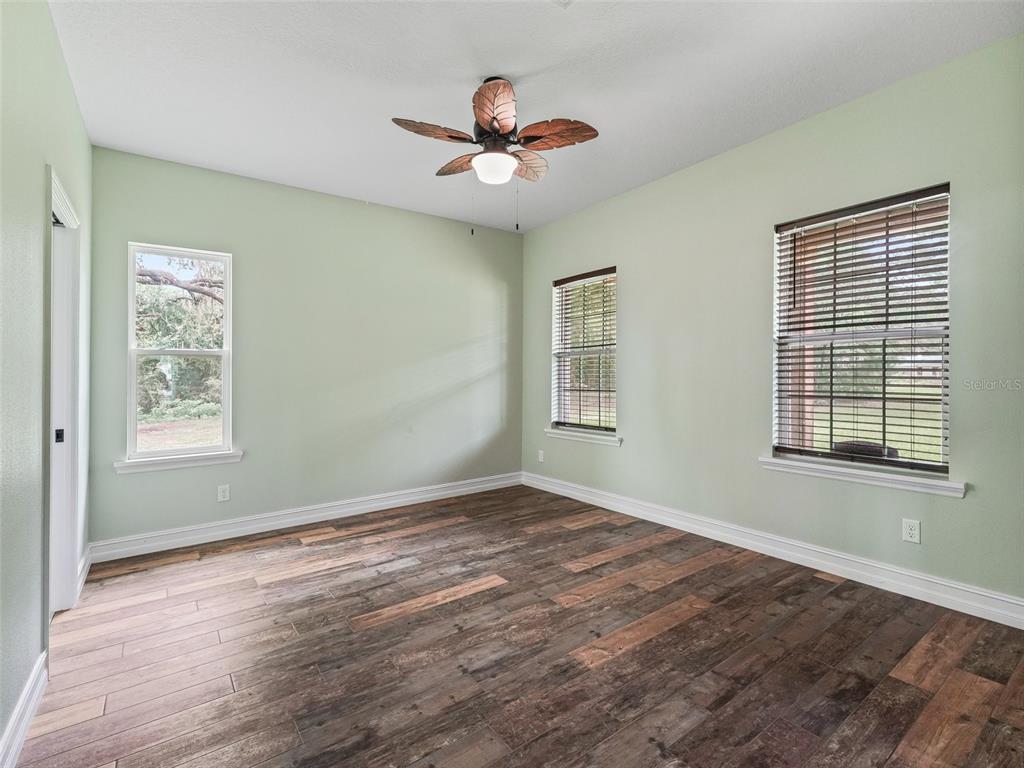 8567 Cr 635 Bushnell Bushnell, FL 33513 - Photo 21 of 46 a view of empty room with wooden floor and fan