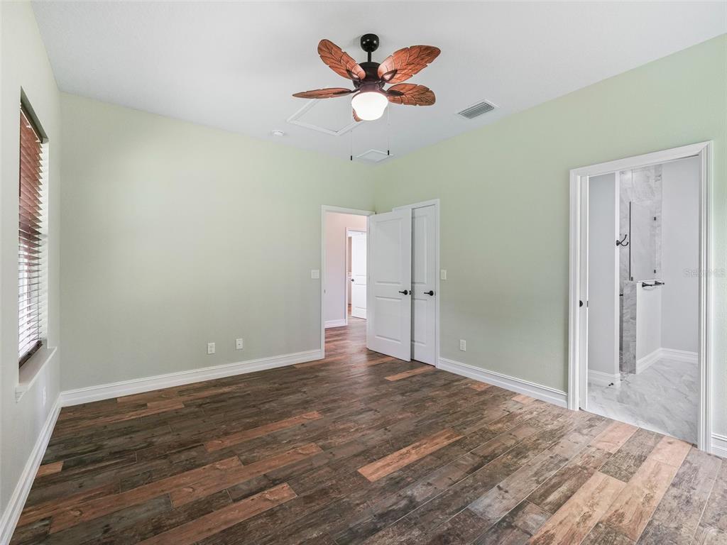 8567 Cr 635 Bushnell Bushnell, FL 33513 - Photo 22 of 46 an empty room with fan and a ceiling fan