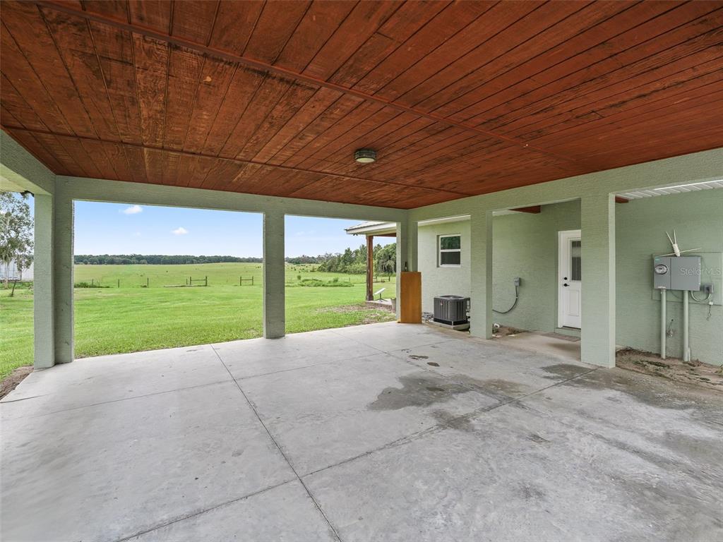 8567 Cr 635 Bushnell Bushnell, FL 33513 - Photo 5 of 46 a view of an empty room with a floor to ceiling window and yard