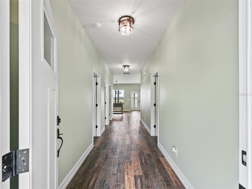 8567 Cr 635 Bushnell Bushnell, FL 33513 - Photo 7 of 46 a view of a hallway with wooden floor