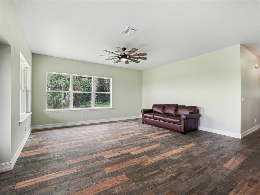 8567 Cr 635 Bushnell Bushnell, FL 33513 - Photo 9 of 46 a living room with a couch and a window