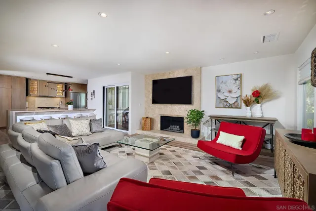 a kitchen with stainless steel appliances granite countertop a dining table chairs refrigerator and sink