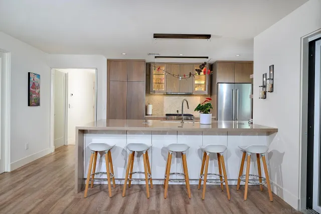 a kitchen with granite countertop a sink stove and cabinets