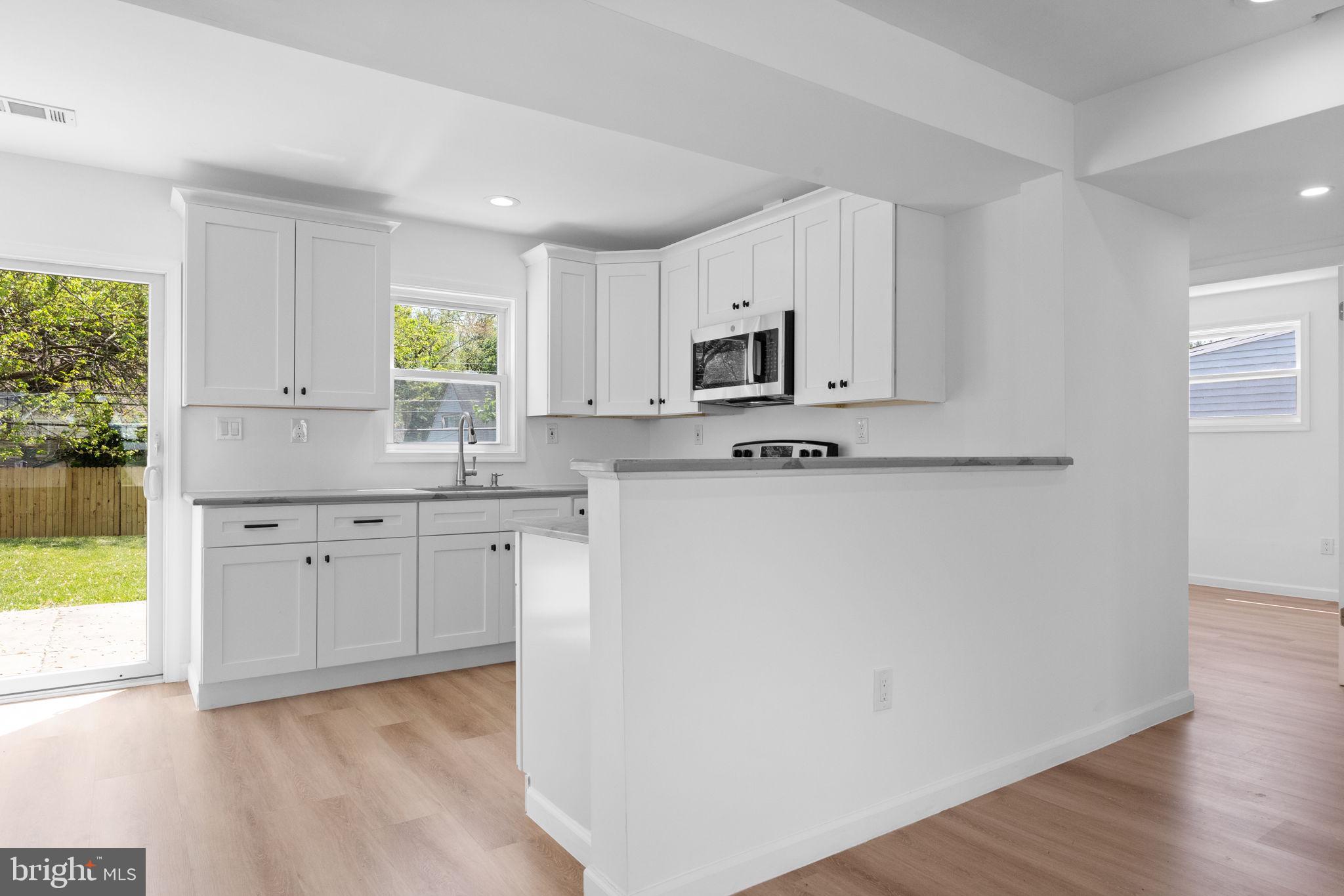 24 Violet Road Levittown, PA 19057 - Photo 6 of 22 a kitchen with cabinets stainless steel appliances a sink and a window