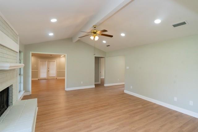 106 Mapleleaf Lane Coppell, TX 75019 - Photo 10 of 36 Spacious living area featuring wood-finish flooring, vaulted ceilings, and recessed lighting