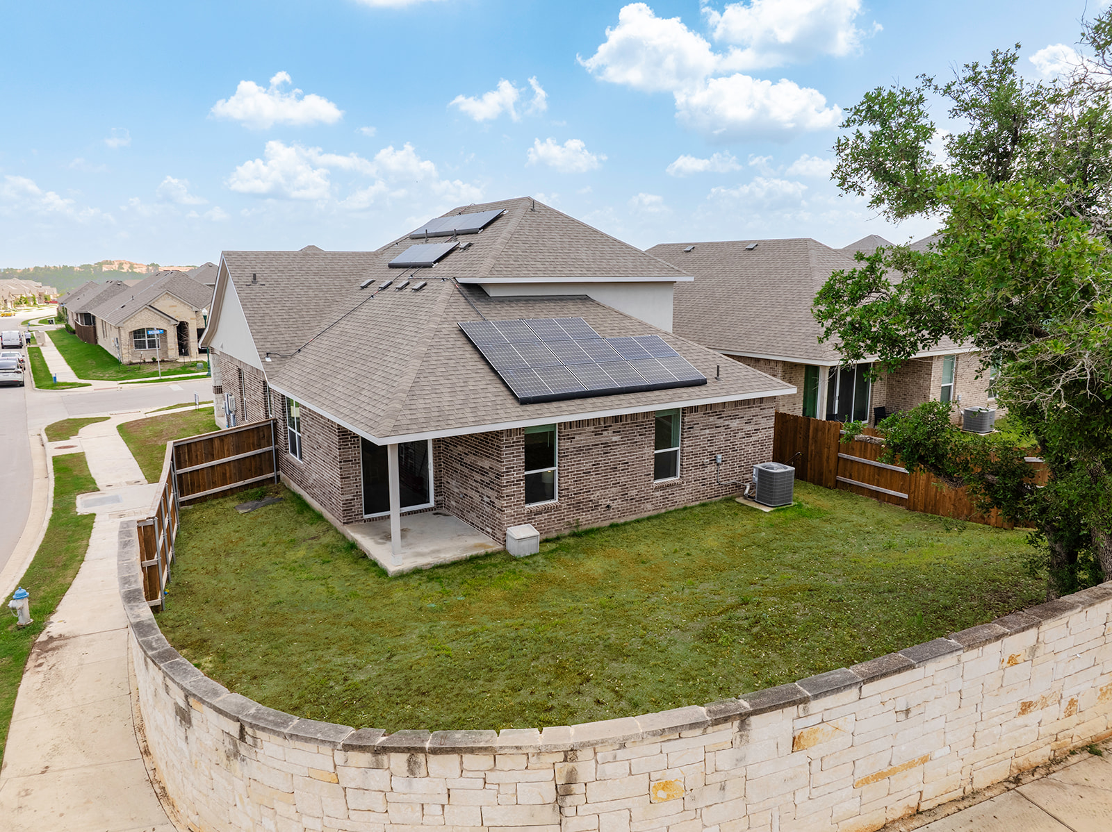 900 Balsora Cove Georgetown, TX 78628 - Photo 26 of 39 A private backyard oasis awaits, enclosed by a robust stone wall and wooden fencing.