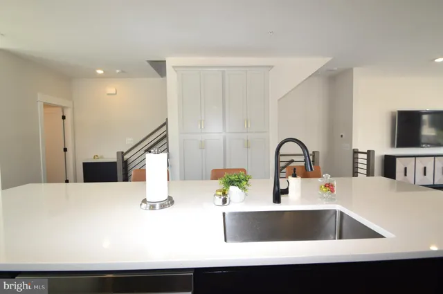 a kitchen with a sink a counter and cabinets