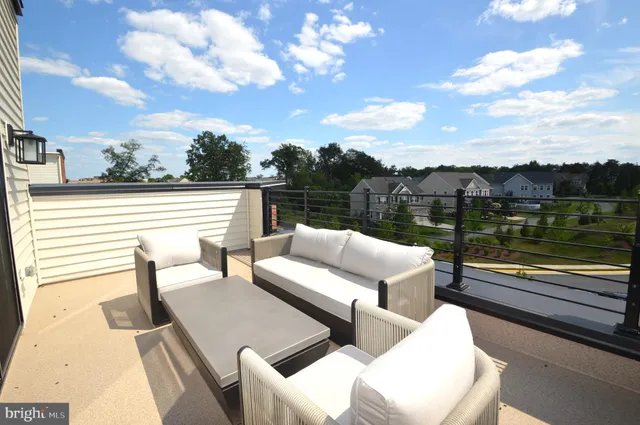 a view of sitting area with furniture and lake view