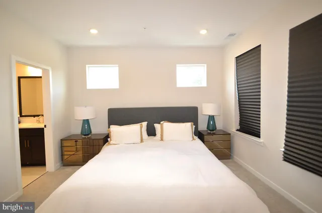 a bedroom with a large bed and a window