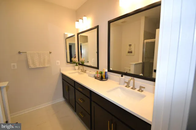 a bathroom with a double vanity sink and mirror