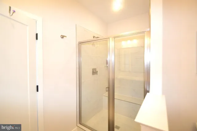a bathroom with a glass shower door