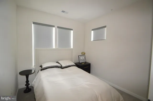 a bedroom with a bed and a table