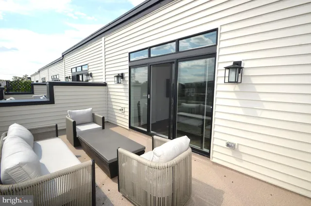 a view of a deck with couches next to a yard