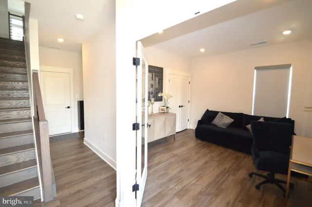 a living room with furniture and a wooden floor