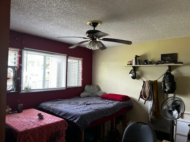 a bedroom with a bed and a window