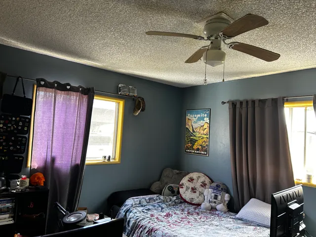 a bedroom with a bed and a chandelier