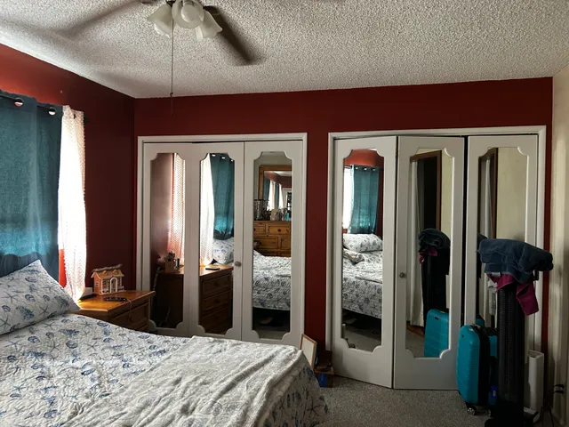 a bedroom with a bed and window