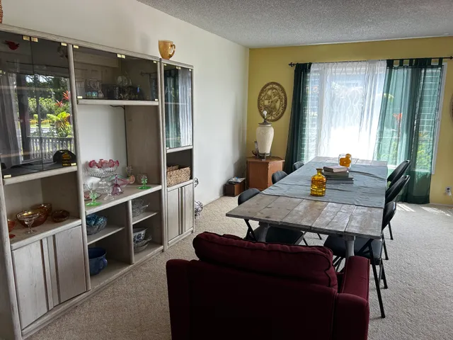 a view of a dining room with furniture and window