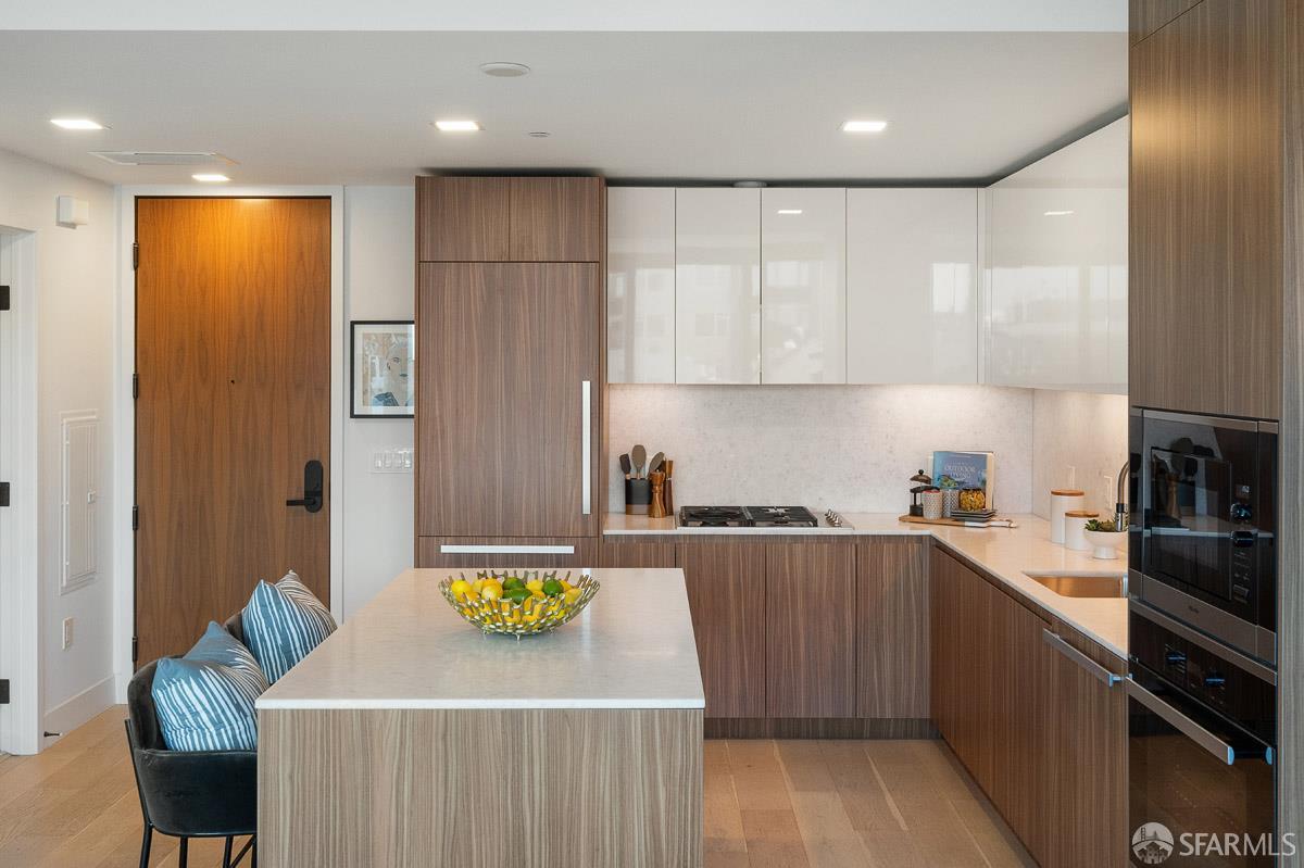 2177 3rd Street, Unit 609 San Francisco, CA 94107 - Photo 11 of 32 a kitchen with stainless steel appliances a refrigerator a sink a stove top oven a counter space and cabinets