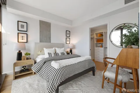 a bedroom with furniture and a rug