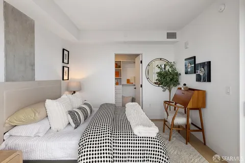 a bedroom with a bed and a couch