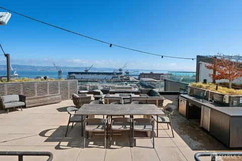 a view of a balcony with wooden floor and seating space