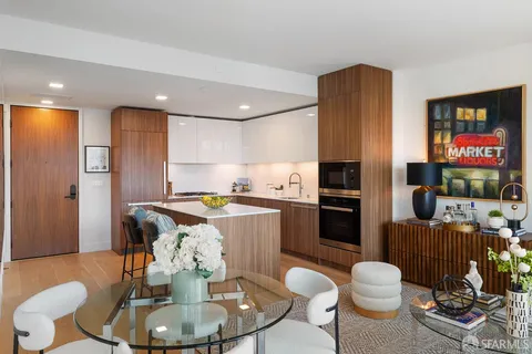 a kitchen with a table chairs stove and refrigerator