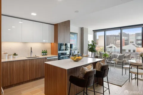 a kitchen with a dining table chairs and white appliances