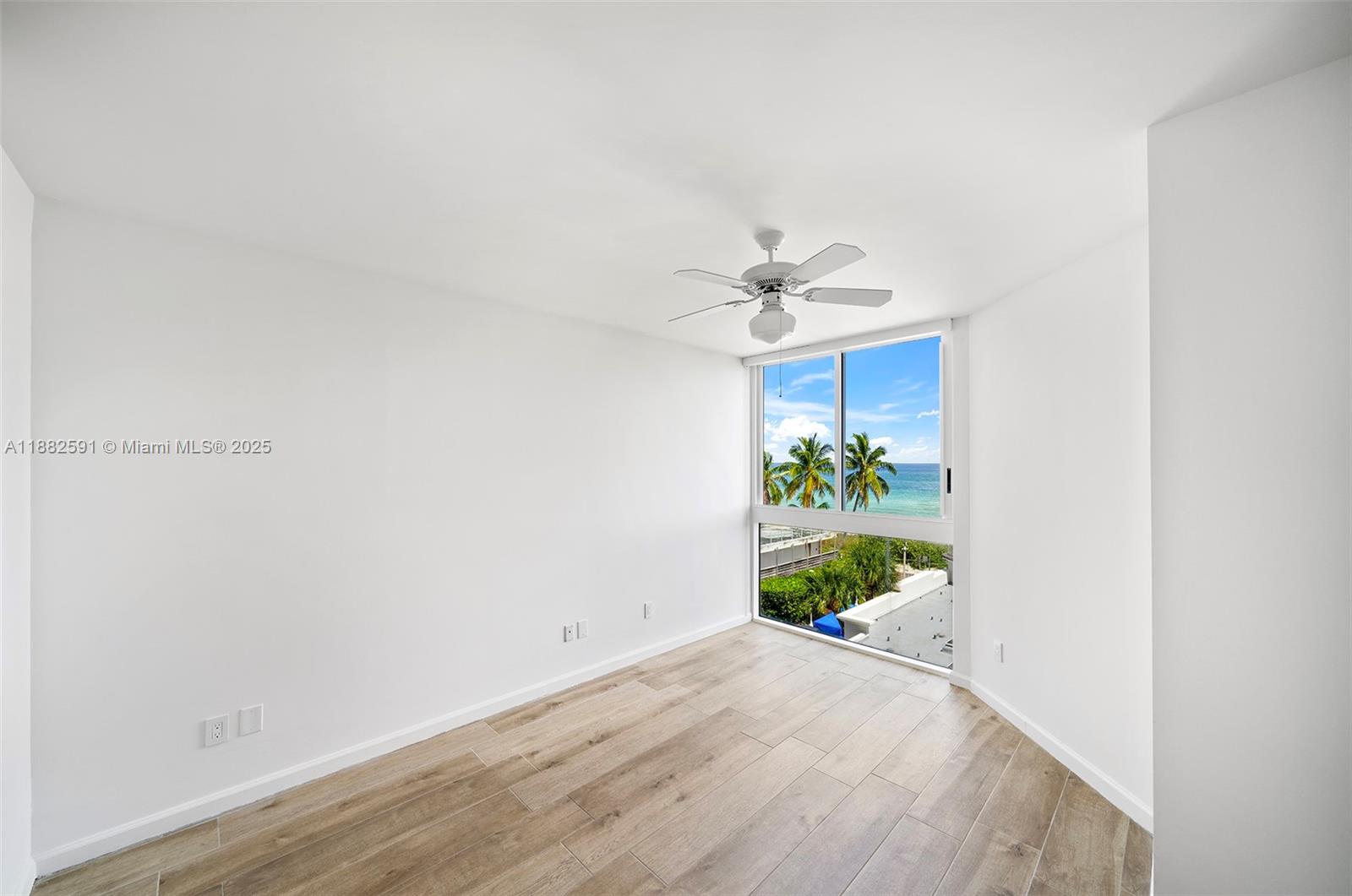 4779 Collins Avenue, Unit 501 Miami Beach, FL 33140 - Photo 25 of 45 a view of a hallway with wooden floor and chandelier