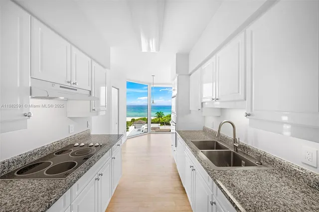 a kitchen with a sink stove and cabinets