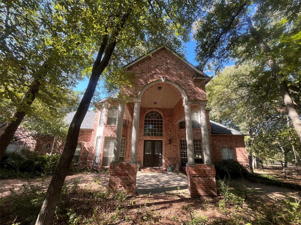 View of front of property featuring brick siding and french doors