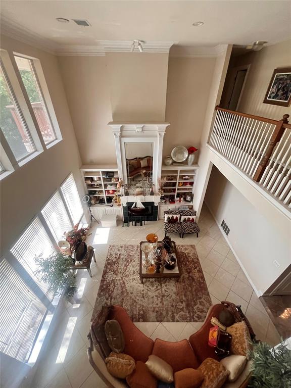 341 Rolling Oaks Ridge Cedar Hill, TX 75104 - Photo 11 of 27 Tiled living area featuring a towering ceiling, ornamental molding, and a fireplace