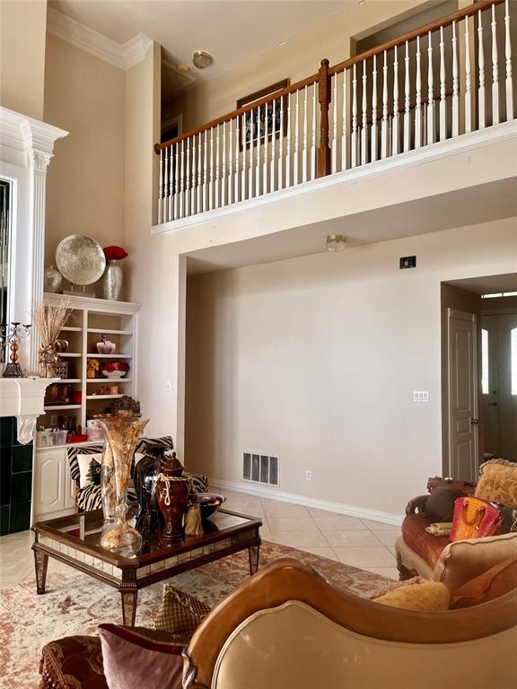 341 Rolling Oaks Ridge Cedar Hill, TX 75104 - Photo 13 of 27 Tiled living area featuring a towering ceiling and crown molding