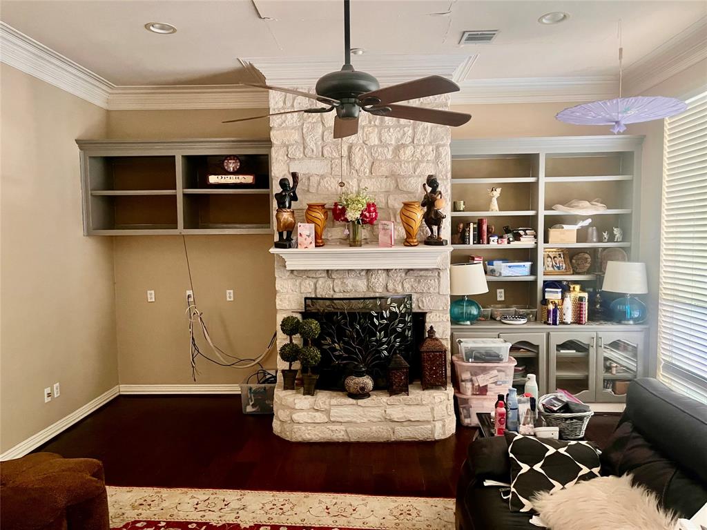 341 Rolling Oaks Ridge Cedar Hill, TX 75104 - Photo 18 of 27 Living area featuring ornamental molding, a fireplace, wood finished floors, and ceiling fan