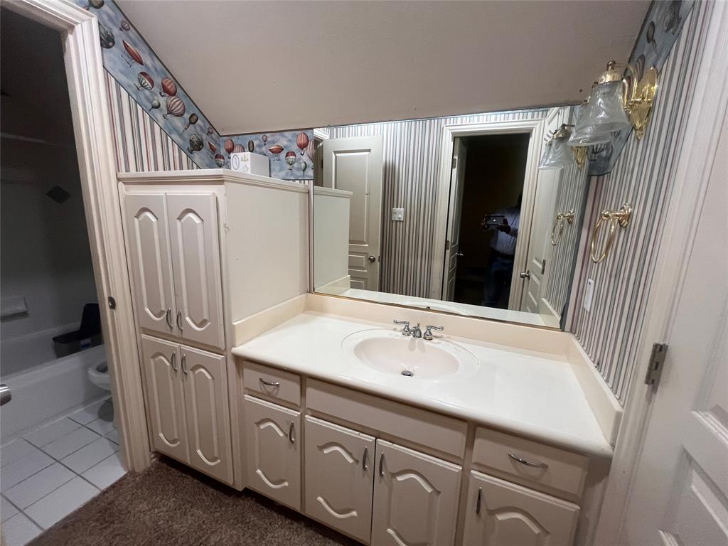 341 Rolling Oaks Ridge Cedar Hill, TX 75104 - Photo 20 of 27 Full bathroom featuring wallpapered walls, vanity, and dark tile patterned flooring