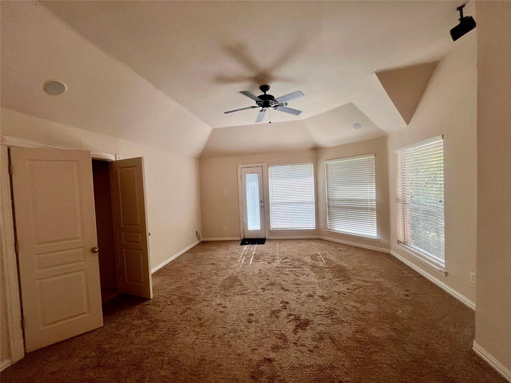341 Rolling Oaks Ridge Cedar Hill, TX 75104 - Photo 24 of 27 Unfurnished room featuring carpet flooring, vaulted ceiling, and a ceiling fan