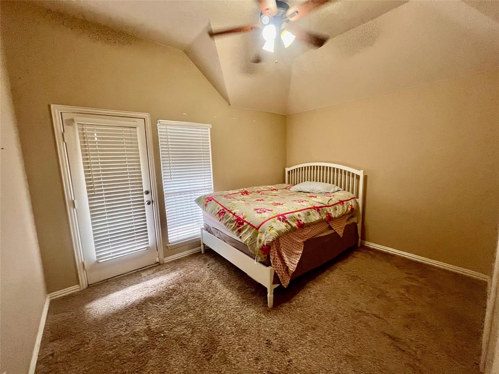 341 Rolling Oaks Ridge Cedar Hill, TX 75104 - Photo 25 of 27 Bedroom featuring carpet flooring, vaulted ceiling, and a ceiling fan