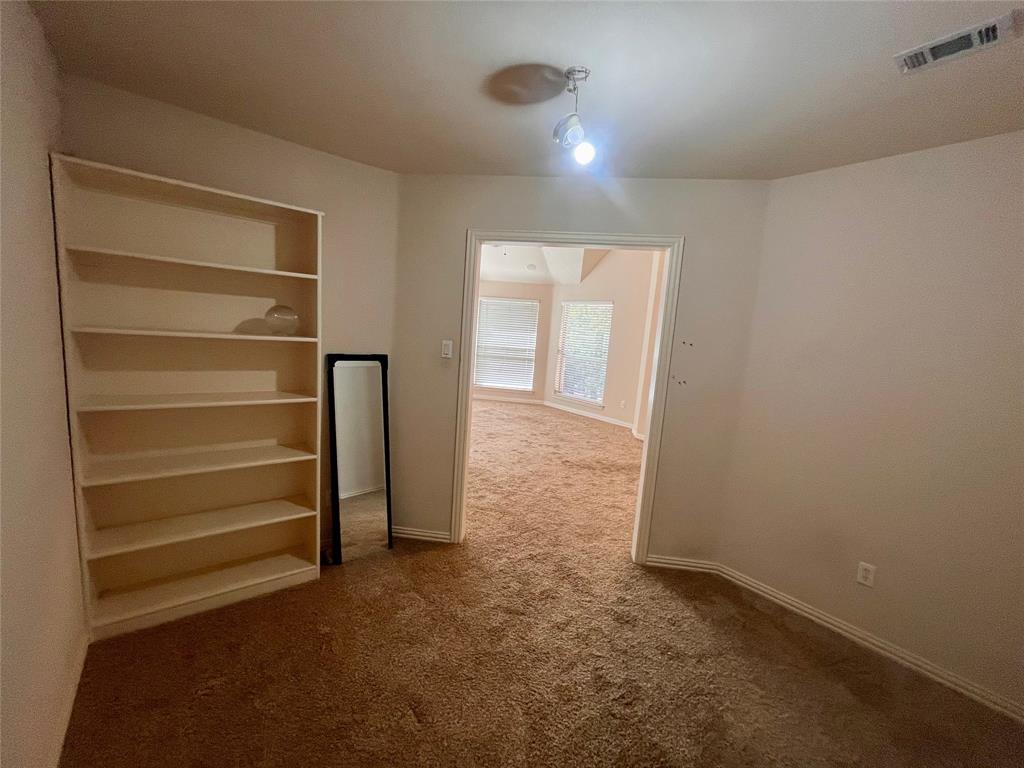 341 Rolling Oaks Ridge Cedar Hill, TX 75104 - Photo 26 of 27 Carpeted empty room with bookcase