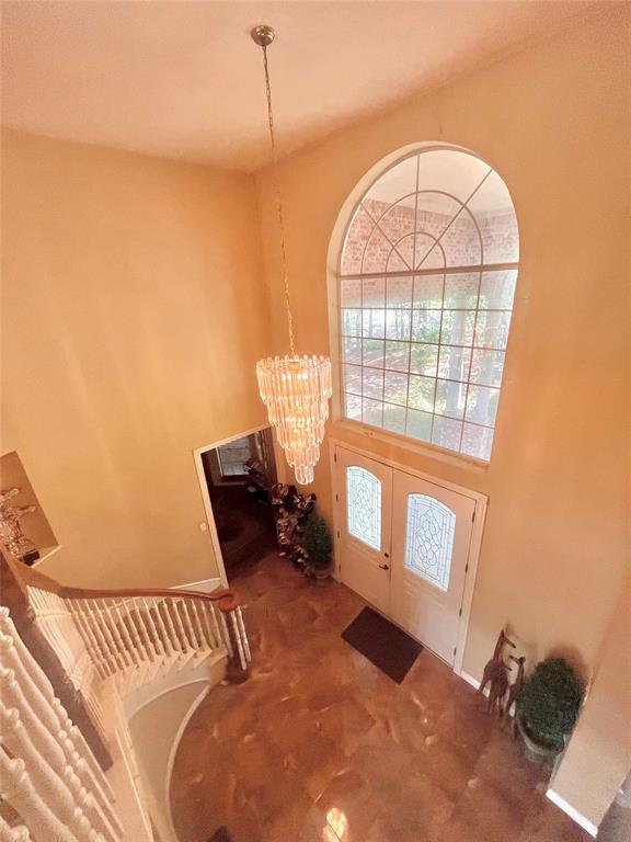 341 Rolling Oaks Ridge Cedar Hill, TX 75104 - Photo 7 of 27 Entrance foyer with carpet, a high ceiling, and chandelier