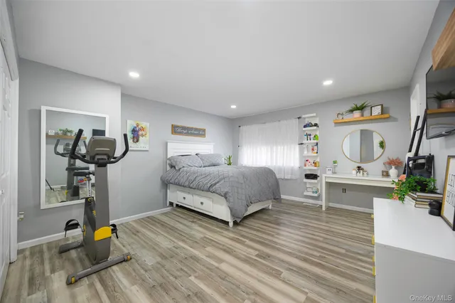 a bedroom with furniture and a wooden floor