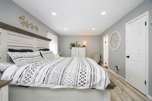 a bedroom with a large bed and a chandelier