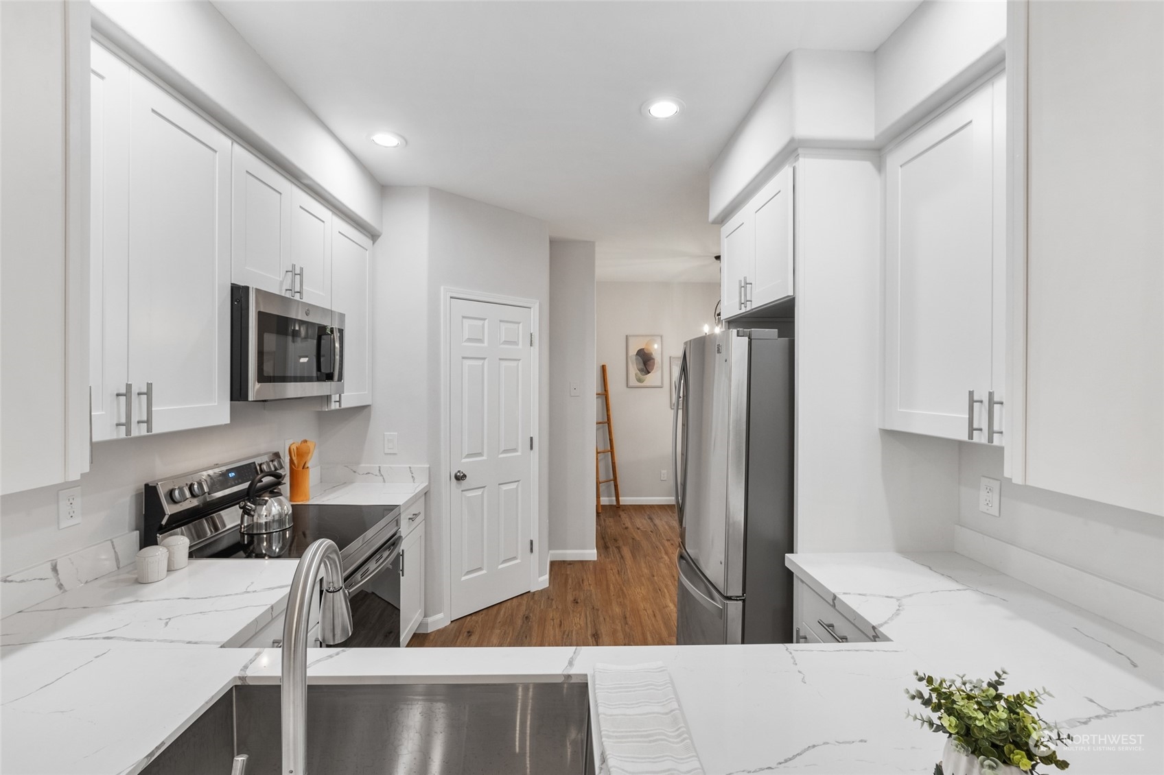 4623 Northeast 6th Court Renton, WA 98059 - Photo 11 of 40 a open kitchen with stainless steel appliances granite countertop a refrigerator and a stove top oven