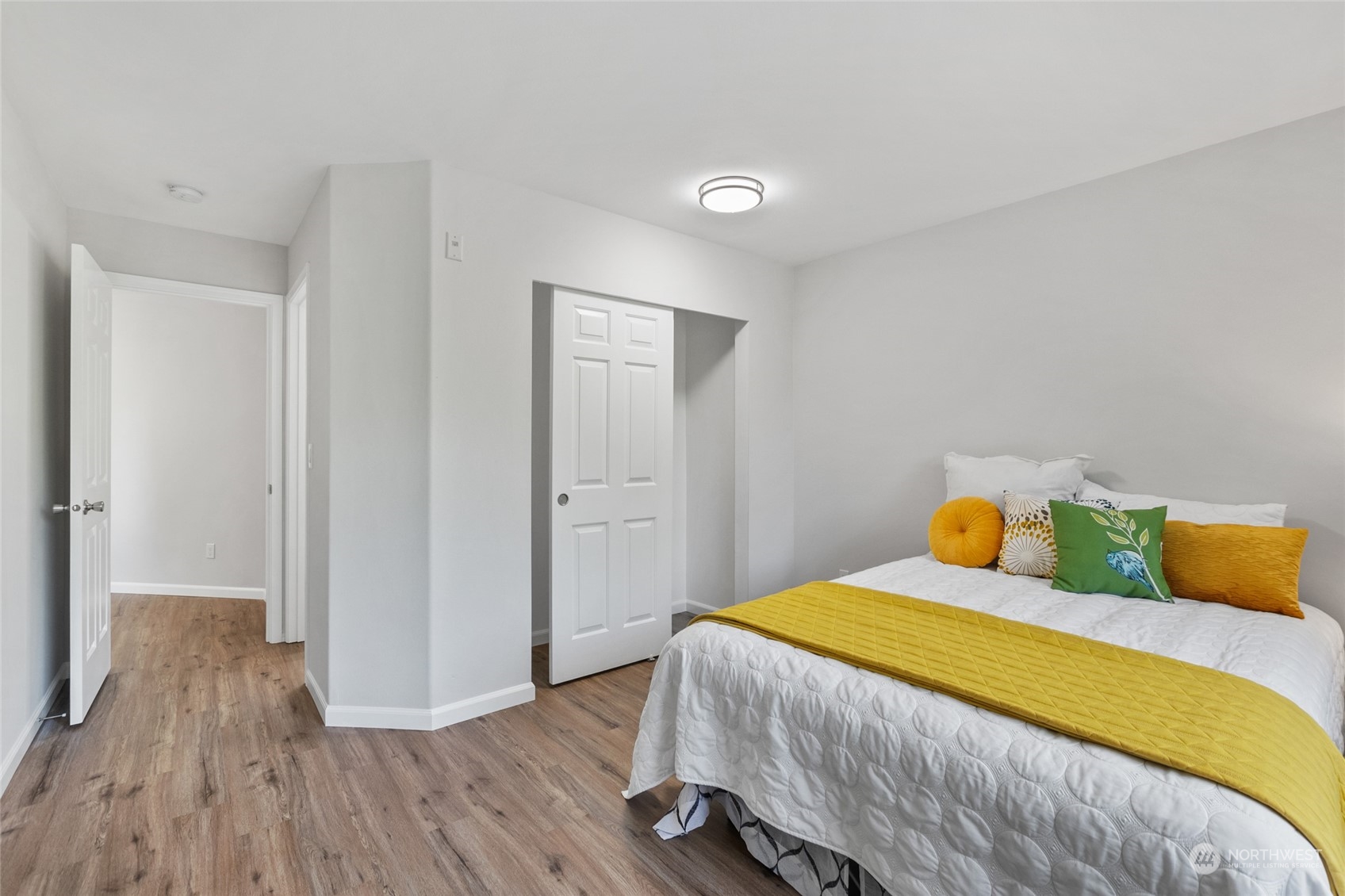 4623 Northeast 6th Court Renton, WA 98059 - Photo 28 of 40 a bedroom with a bed and wooden floor