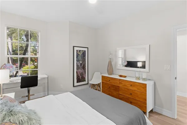 a bedroom with a bed and a chair
