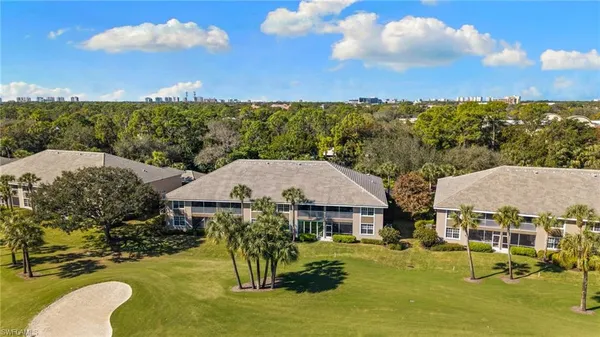 an aerial view of a house with a garden and lake view