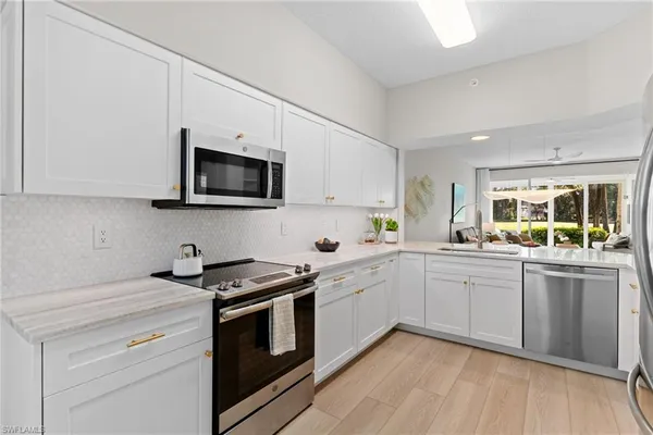 a kitchen with sink a microwave and stove