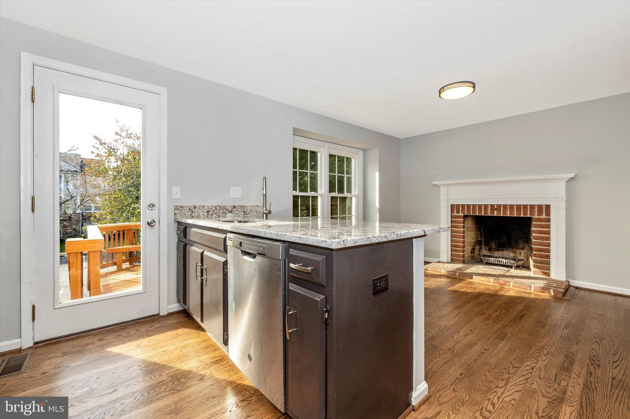 8001 Hollow Reed Court Frederick, MD 21701 - Photo 11 of 33 a kitchen with stainless steel appliances granite countertop a stove a sink and a fireplace
