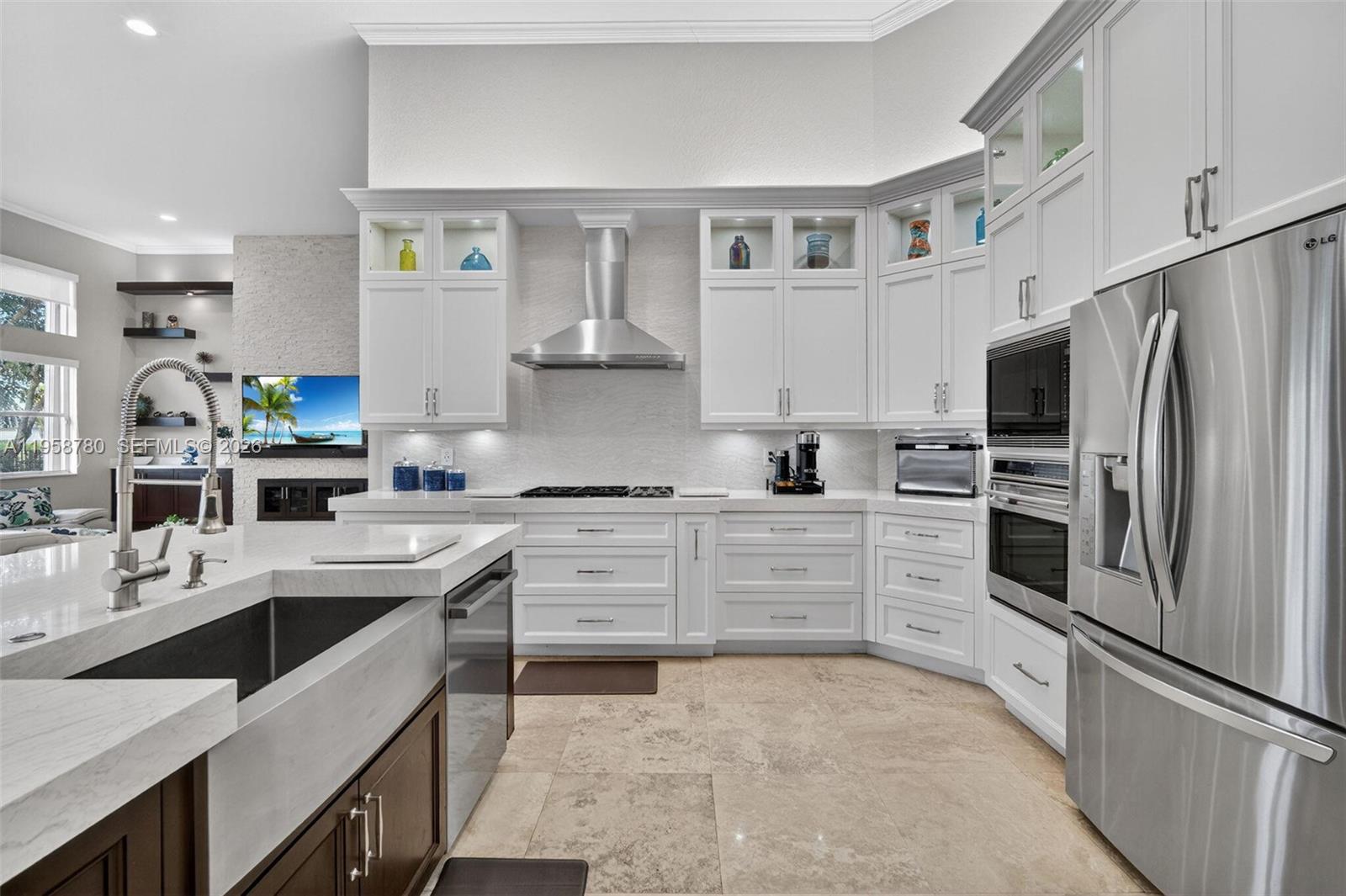 14931 Southwest 38th Street Davie, FL 33331 - Photo 39 of 82 a kitchen with white cabinets and stainless steel appliances